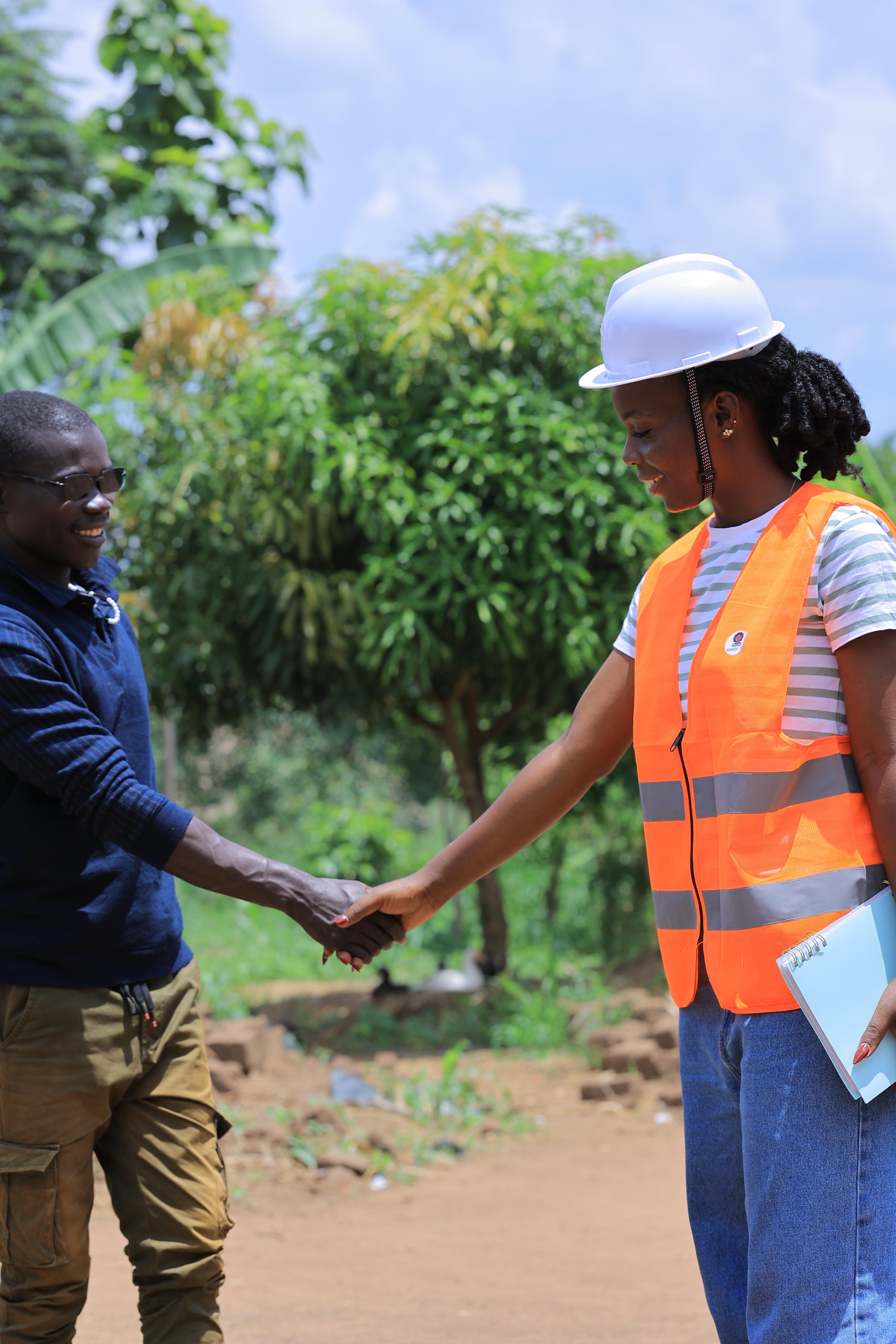 Sandi AI field worker shaking hands with a farmer